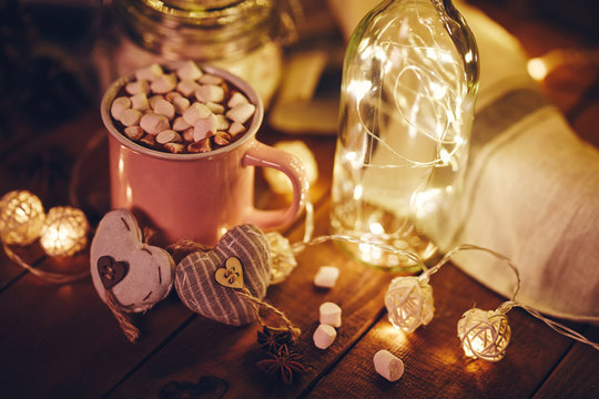 Mug with hot chocolate, marshmallows and lights