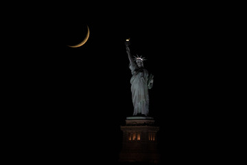 statue of liberty with a moon