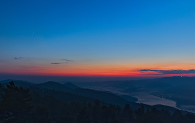 Fototapeta na wymiar Mountain sunset on the Arvo lake, in the heart of the Sila National Park, Calabria, Italy