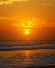 Beach of the ocean and golden sun rise.
