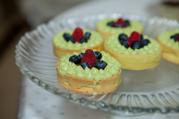 Homemade shortbread tartlets with custard cream, strawberry and blueberry