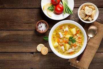 Chicken soup with noodles and vegetables in white bowl on  wooden background - Powered by Adobe