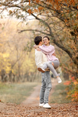 Fototapeta premium Couple in love in the autumn leaves