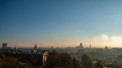 Fototapeta na wymiar Foggy and cloudy cityscape of Gdansk with St. Mary's Basilica.