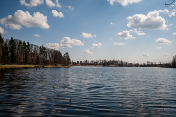 colorful sunset on the lake with water reflections and dramatic storm clouds above