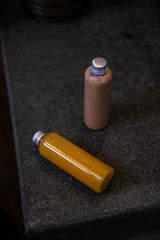 Spa cosmetics in plastic bottles on dark gray concrete table, bathroom interior. Beauty blogger, salon therapy, branding mockup, package, minimalism concept