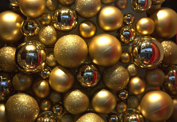 Shiny golden Christmas ornaments are folded.