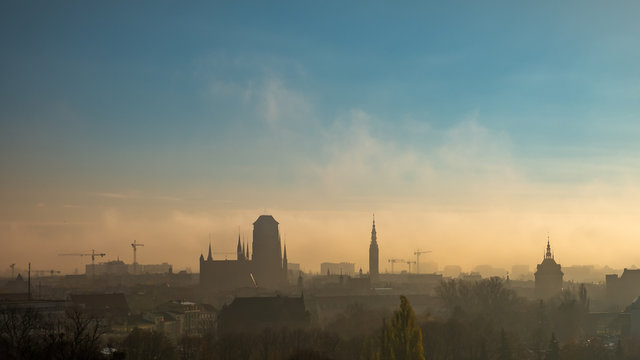 Foggy and cloudy cityscape of Gdansk with St. Mary's Basilica.