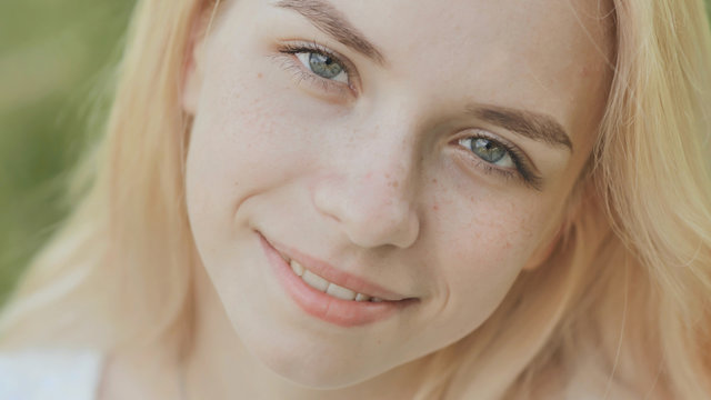 Close-up face of a smiling 19 year old blonde girl.