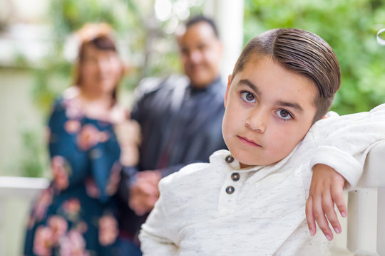 Portrait of Mixed Race Couple Standing Behind Young Son