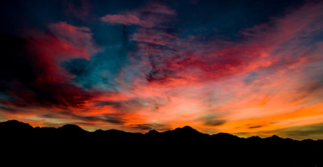 Aerial, drone view of sunset above Tubac, Arizona with mountin silhouettes and beautiful colors 
