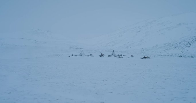 In the middle of Arctic lots of yurts on the field taking video of drone. 4k. slow motions