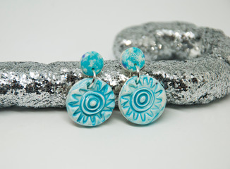 Small light blue winter stud earrings of polymer clay with christmas decor. Handmade jewelry isolated.