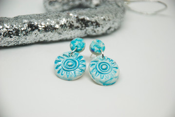 Small light blue winter stud earrings of polymer clay with christmas decor. Handmade jewelry isolated.