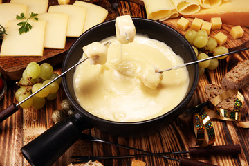 Gourmet Swiss fondue dinner on a winter evening with assorted cheese