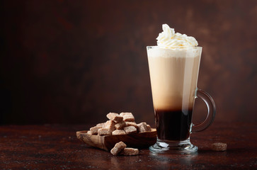 Coffee drink with cream and pieces of brown sugar.
