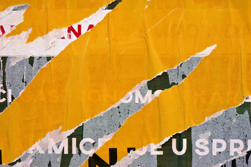 Old grunge ripped torn vintage collage street posters creased crumpled paper surface placard texture background backdrop