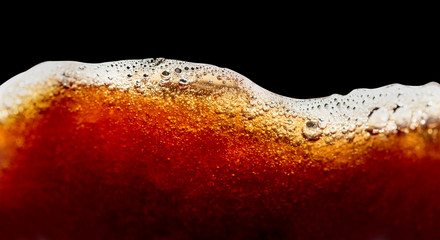 Close up of coffee splashes on a black background.