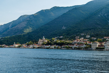 Fototapeta na wymiar The city on the beach at the foot of the high mountains in Montenegro