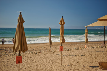sun umbrellas closed on the beach