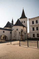 Obraz premium Kostel Povyseni sv. Krize church with statue of sv. Florian behind in Karvina city in Czech republic