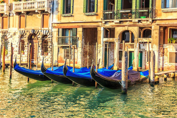 Fototapeta na wymiar Gondolas moored in Grand Canal in Venice, Italy