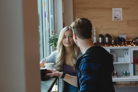 Couple interacting while having coffee