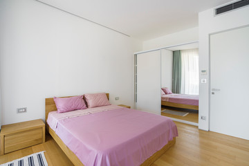 Fototapeta na wymiar Interior of a spacious light bedroom with windows in a luxury villa