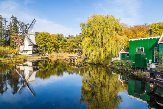 Historic Dutch scene with an old shipyard, wooden barn and water windmill in the open air museum in Arnhem in the Netherlands