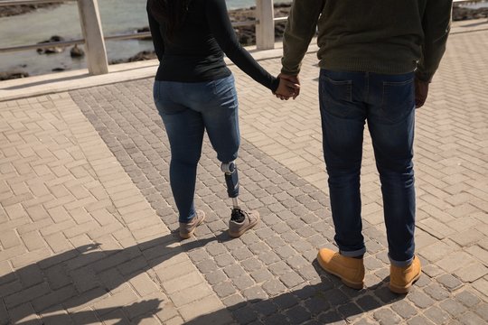 Couple holding hands on promenade