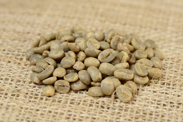 green coffee grains on burlap, macro