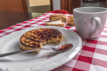 Breakfast on the table with checkered tablecloth