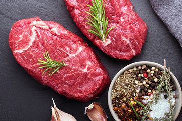 Two beef steaks with seasoning.Flat lay