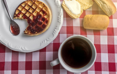 Breakfast on the table with checkered tablecloth