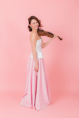 woman with a violin on a pink background