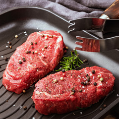 Two beef steaks seasoned in a pan