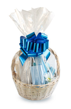 gift basket, hamper packed in transparent paper with a big blue bow isolated on a white background