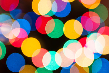 Christmas background in defocused lights. Colorful bokeh.