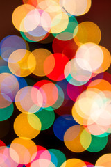 Christmas background in defocused lights. Colorful bokeh.