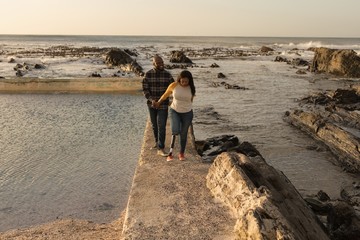 Smiling couple walking on promenade