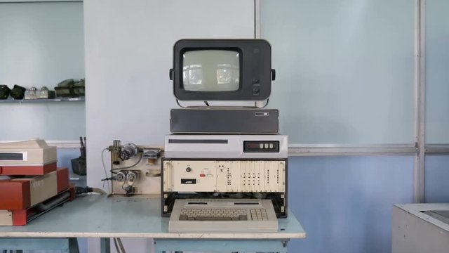 Old computer with CRT monitor with keyboard in classroom. Concept: retro style, outdated technology 