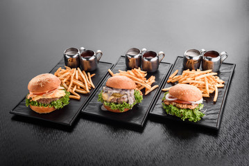 various burgers with french fries hamburgers on plate