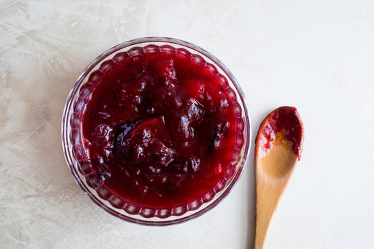 Close up of bowl of plum sauce and spoon