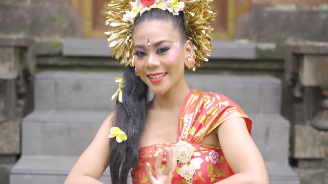 Closeup of beautiful Balinese woman laughing and smiling at camera. Shot in Bali, Indonesia in 4K format
