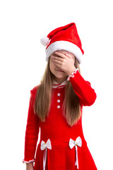 Christmas girl with closed the eyes with her hand, wearing a santa hat isolated over a white background