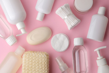 Obraz premium Body and skin care products in white packaging on a pink delicate background. Personal hygiene products. View from above. Flat lay