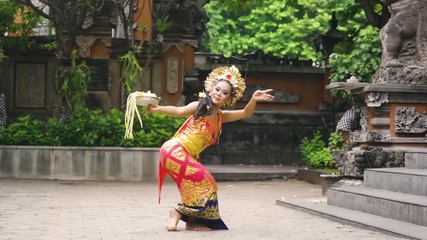 Balinese female dancer performing artistic dance in colorful costume. Shot in 4K in Bali, Indonesia 
