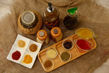 Natural spices, seasonings and sauces on a canvas background. The concept of natural food.