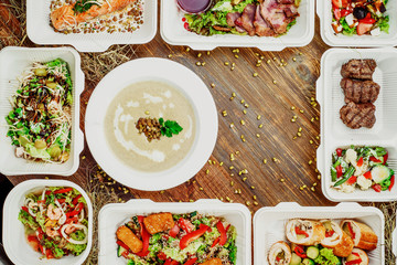 Healthy food delivery. Take away for diet. Fitness nutrition, vegetables, meat and fruits in white eco boxes. Top view, flat lay at natural wood with copy space