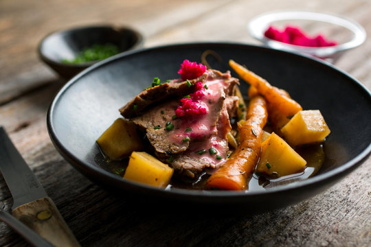 Close Up Of Beef And Stew Served In Bowl On A Wooden Table